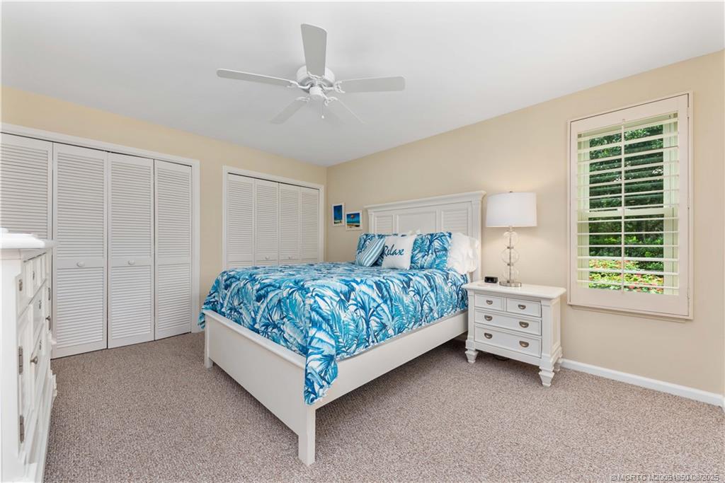 12813 Northwest Cinnamon Way Palm City, FL 34990 - Photo 19 of 33 a bedroom with a bed and a window