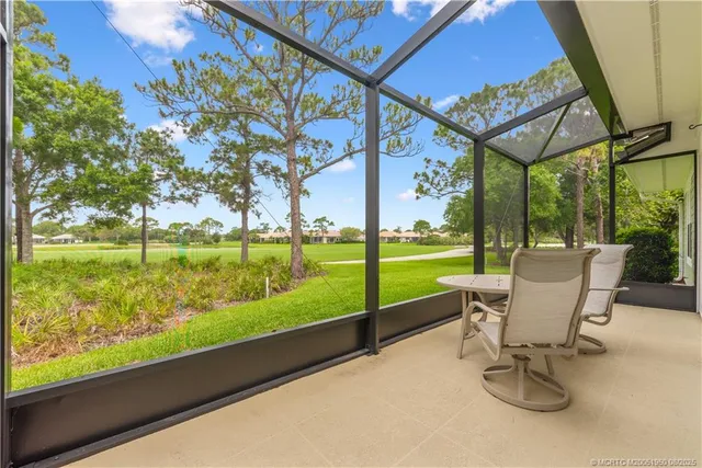 a view of a two chairs in the deck next to a yard