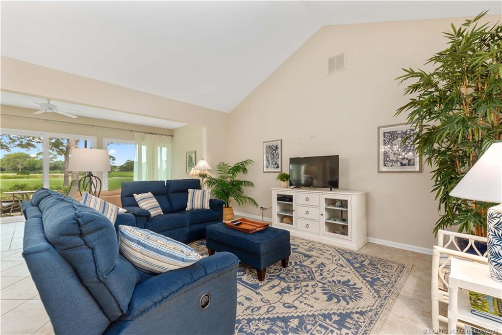 12813 Northwest Cinnamon Way Palm City, FL 34990 - Photo 6 of 33 a living room with furniture and a flat screen tv