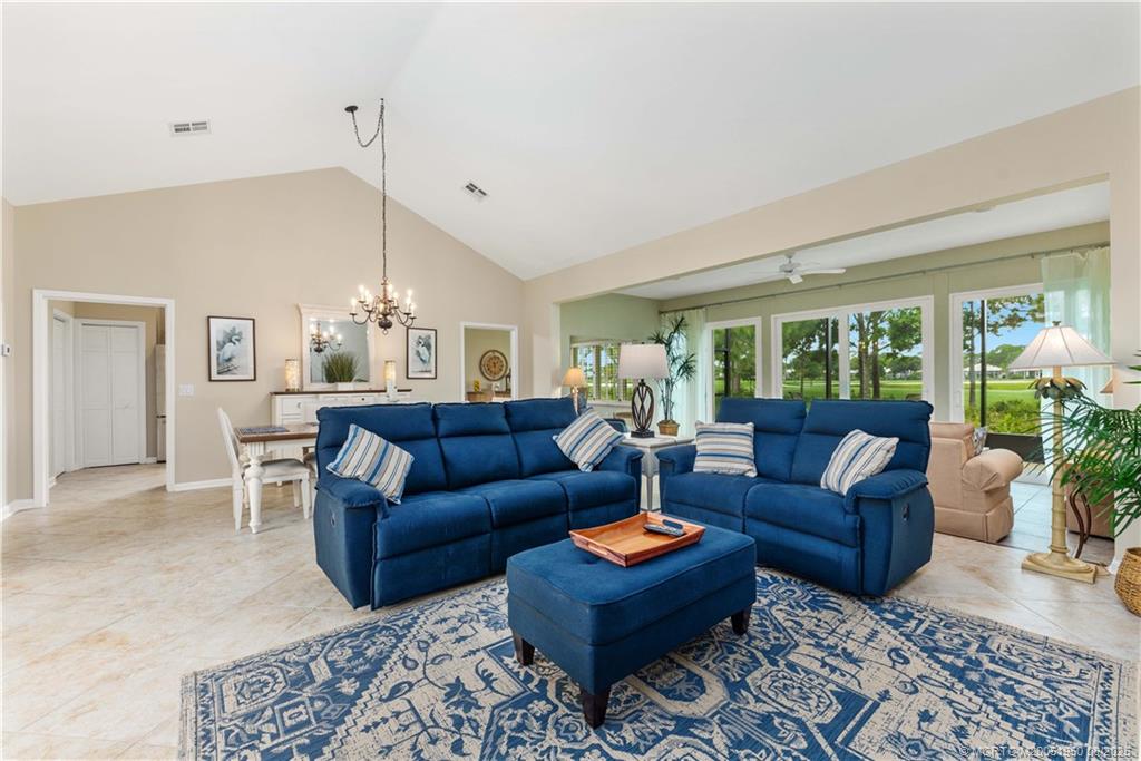 12813 Northwest Cinnamon Way Palm City, FL 34990 - Photo 7 of 33 a living room with furniture potted plant and a large window