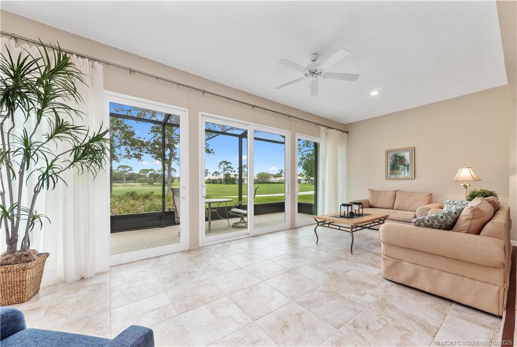 12813 Northwest Cinnamon Way Palm City, FL 34990 - Photo 8 of 33 a living room with furniture and a large window