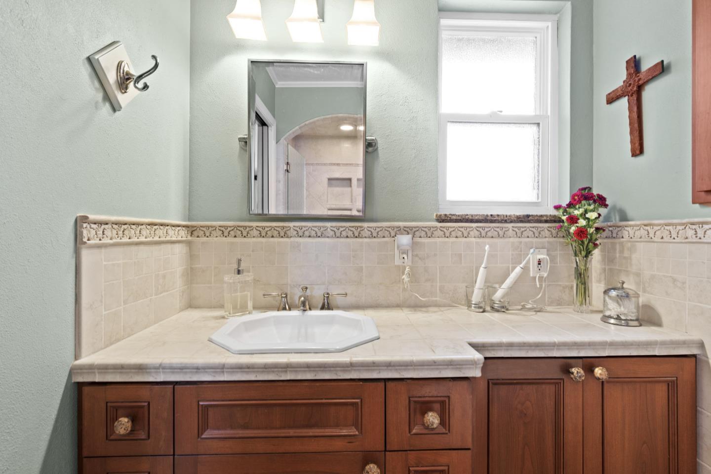 2841 Pruneridge Avenue Santa Clara, CA 95051 - Photo 34 of 53 a bathroom with a granite countertop sink a large mirror and a window