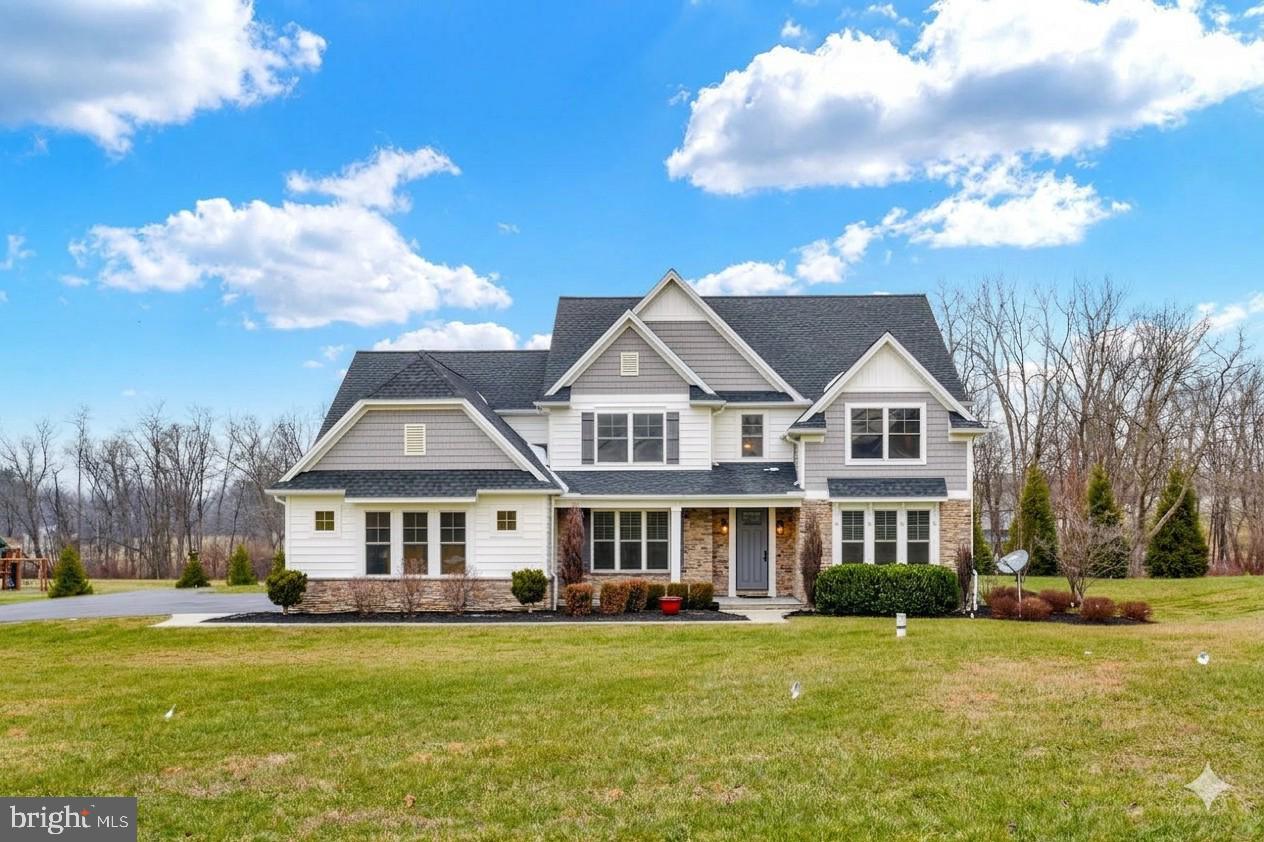 a front view of a house with a big yard
