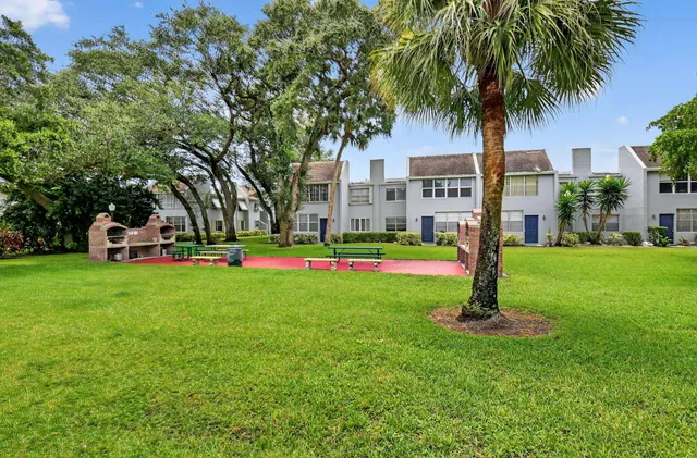 a front view of a garden with palm trees