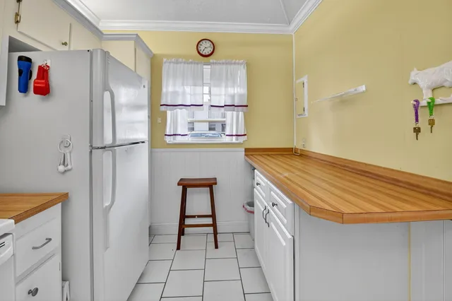 a kitchen with a refrigerator and a stove