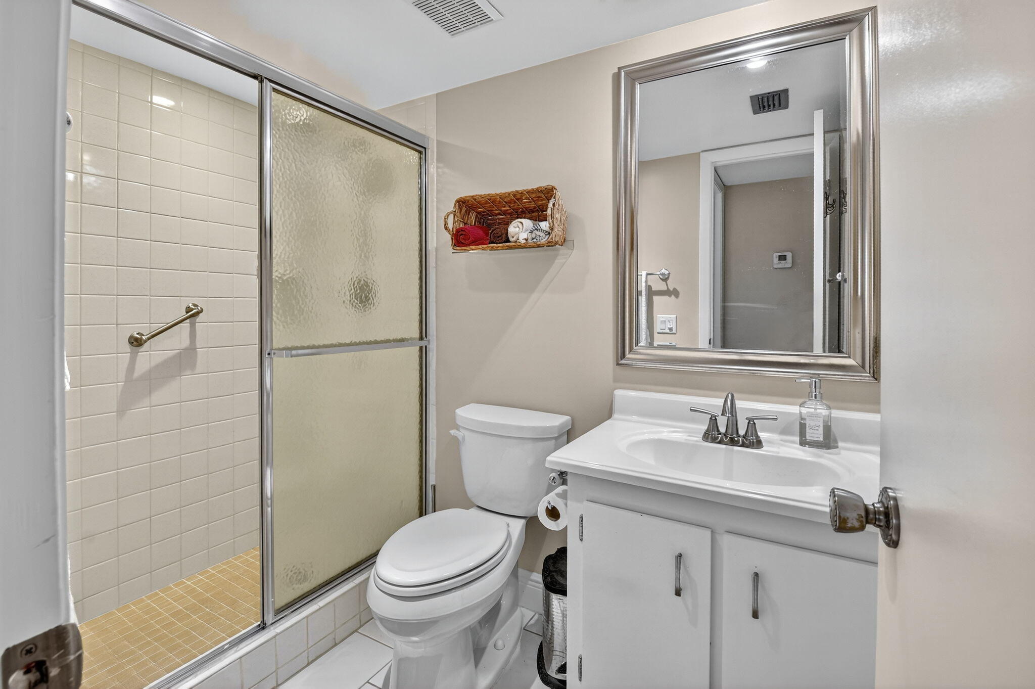 2860 Southwest 22nd Avenue, Unit 4030 Delray Beach, FL 33445 - Photo 8 of 37 a bathroom with a sink a toilet and shower