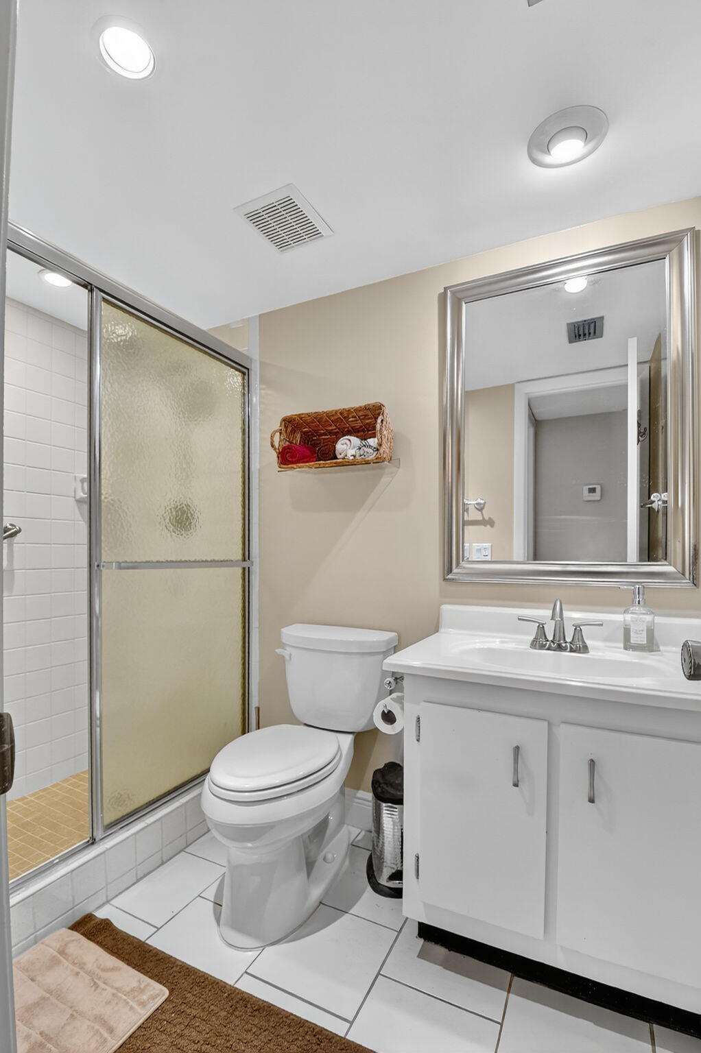 2860 Southwest 22nd Avenue, Unit 4030 Delray Beach, FL 33445 - Photo 10 of 37 a bathroom with a sink a toilet and shower