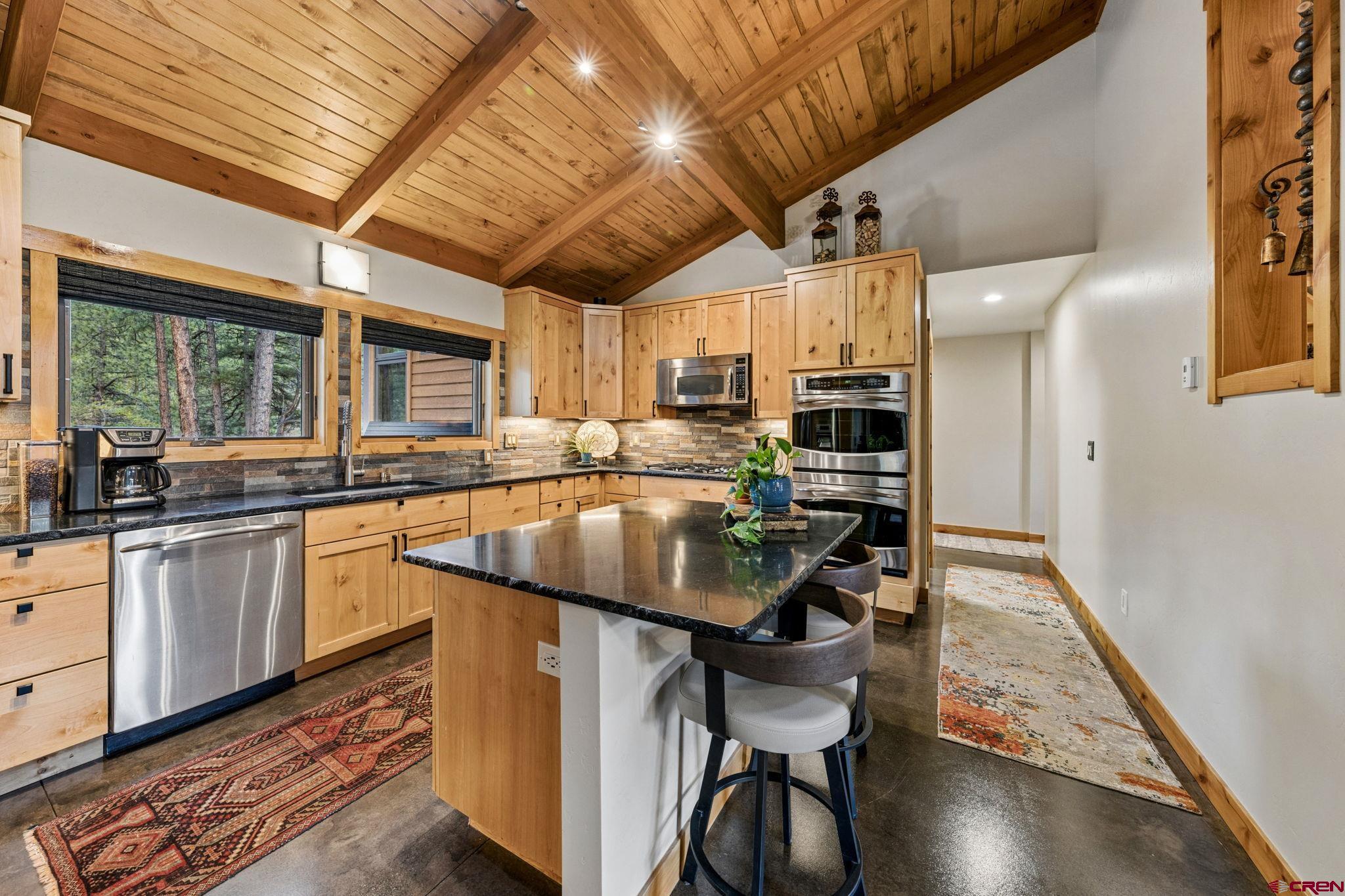 24 Monarch Crest Trail Durango, CO 81301 - Photo 12 of 45 a kitchen with stainless steel appliances granite countertop a sink a stove and cabinets