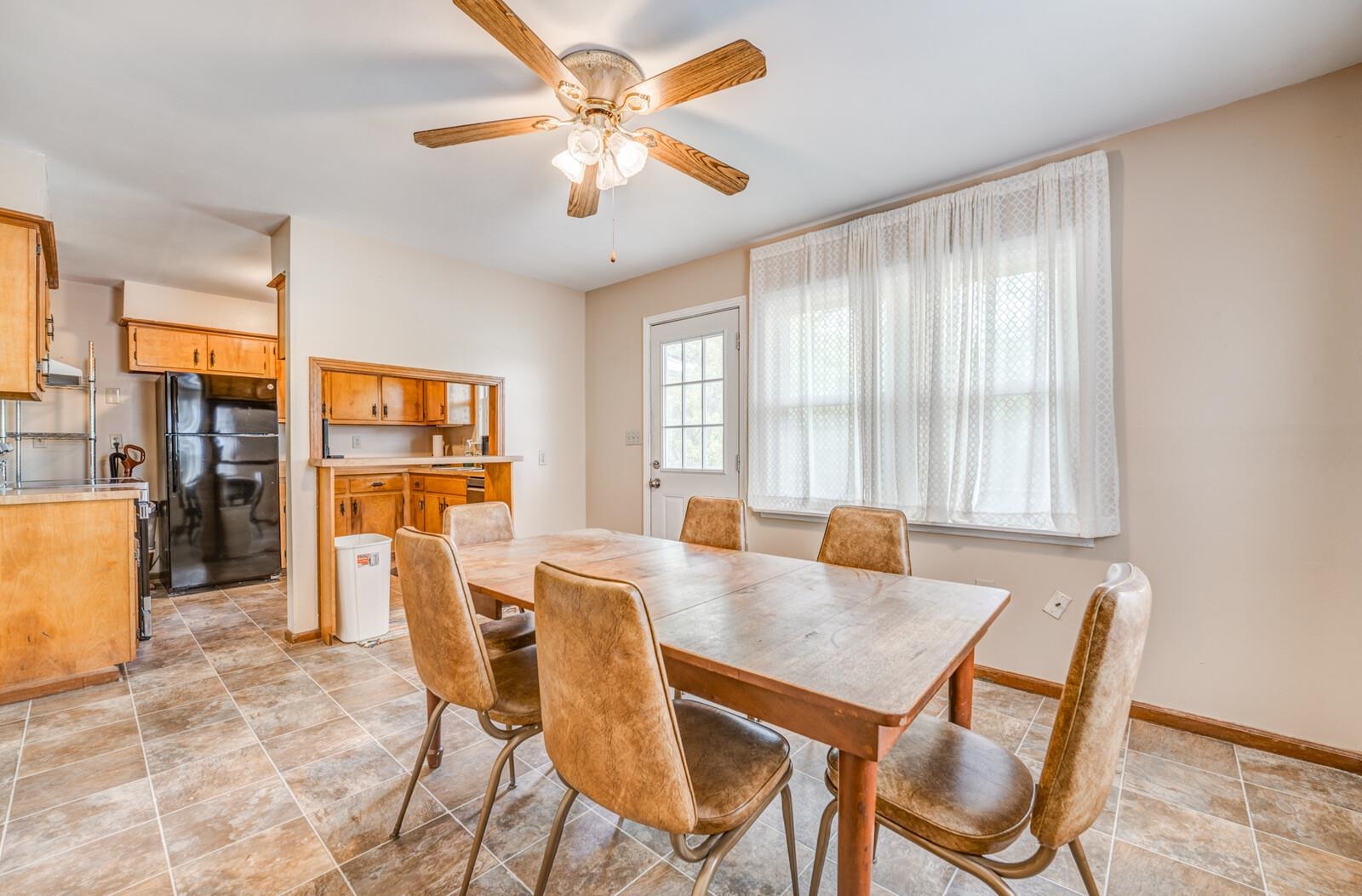 6125 Warren Road Oakland, TN 38060 - Photo 14 of 40 Dining area featuring ceramic tile flooring, a ceiling fan with light fixture, and a white paneled door with window panes