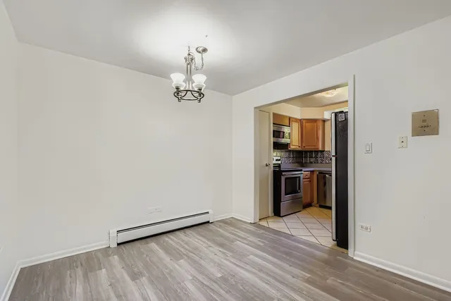 a view of a kitchen with a sink and dishwasher wooden floor