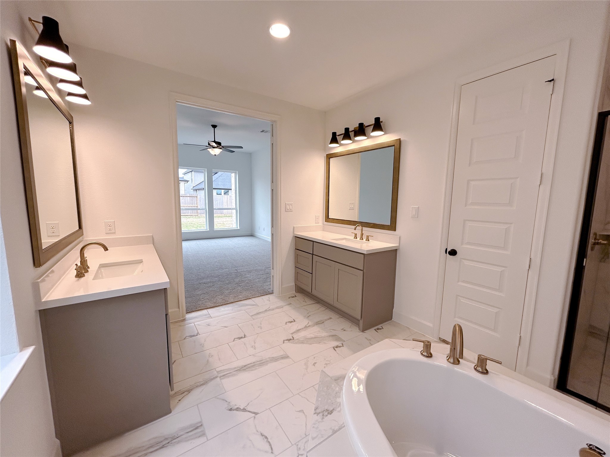 29847 Longleaf Grv Lane Fulshear, TX 77441 - Photo 29 of 39 a bathroom with a sink toilet and tub