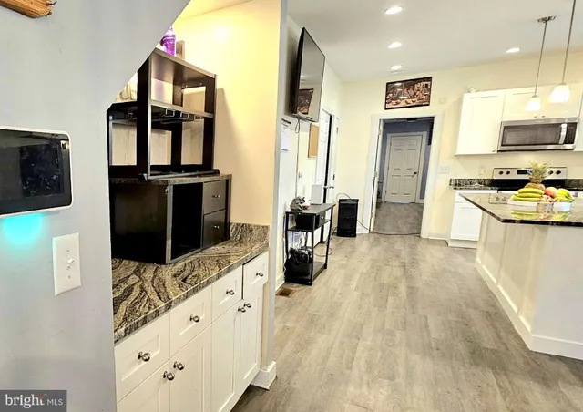 a kitchen with stainless steel appliances a refrigerator and a stove top oven