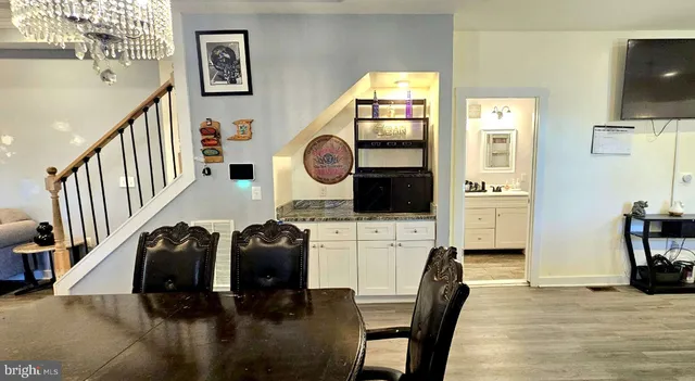 a hallway with a computer on a table and couches