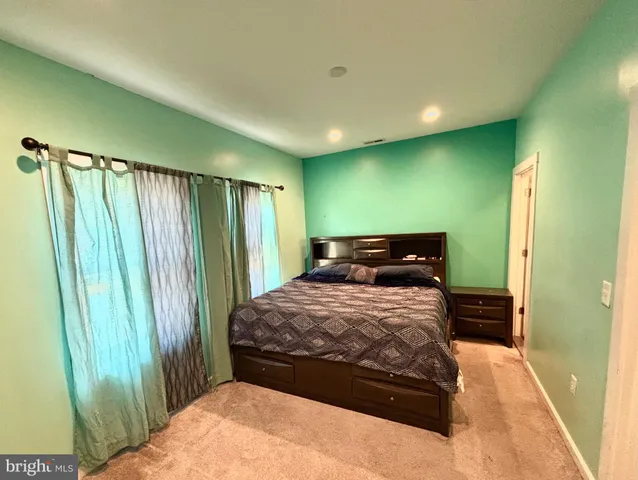 a bedroom with a bed and a mirror