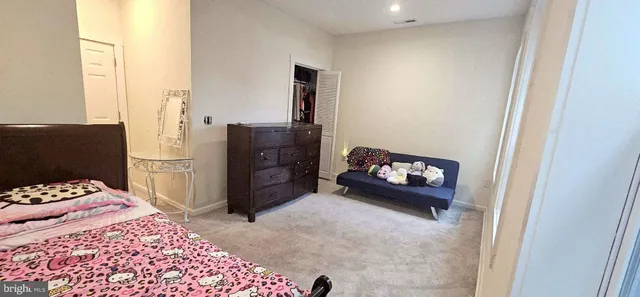 a bedroom with a bed and a cabinets