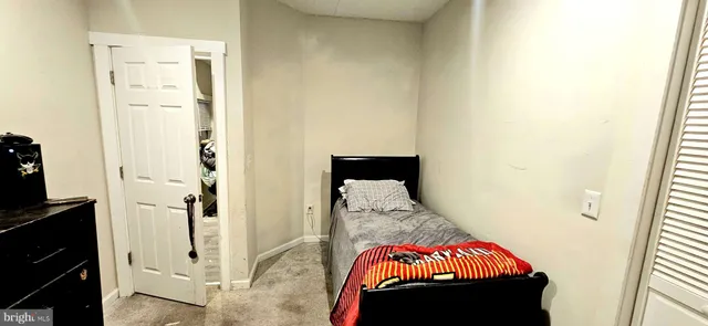 a bedroom with a bed and a tv