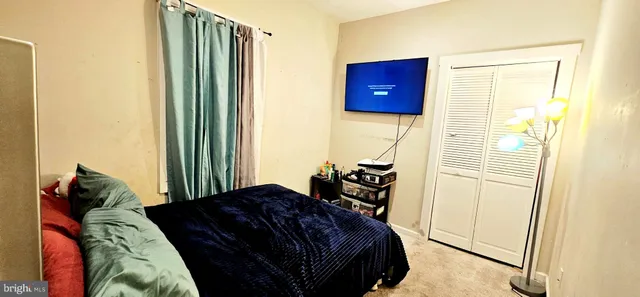 a bedroom with a bed and a closet