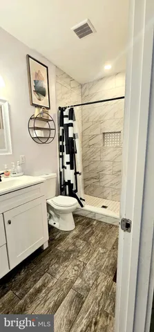 a bathroom with a sink toilet and shower