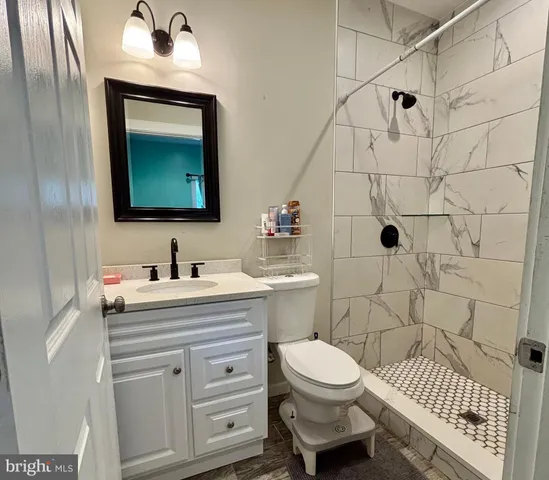 a bathroom with a sink toilet a mirror and shower