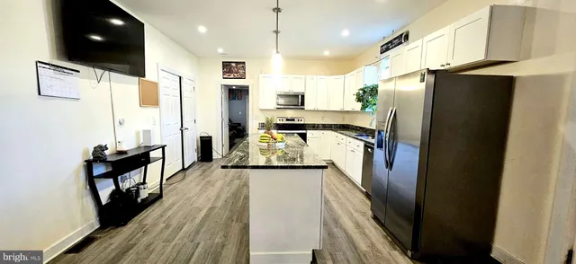 a kitchen with stainless steel appliances a refrigerator and a stove
