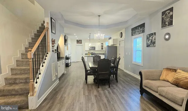 a view of a dining room with furniture and wooden floor