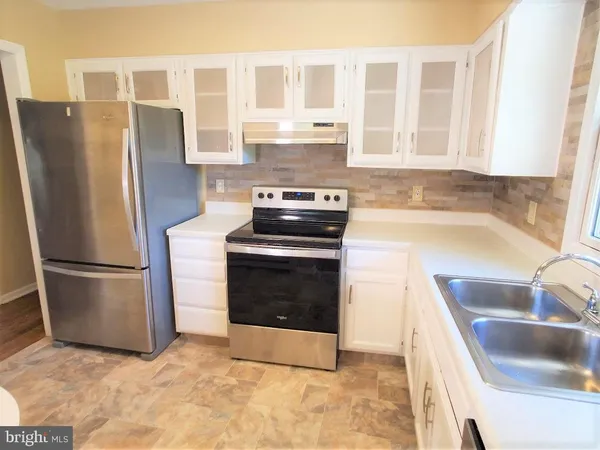 a kitchen with a refrigerator sink and stove