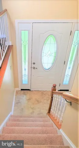 a view of a room with wooden floor and window