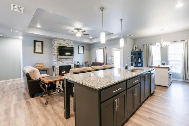 a large kitchen with kitchen island a sink table and chairs