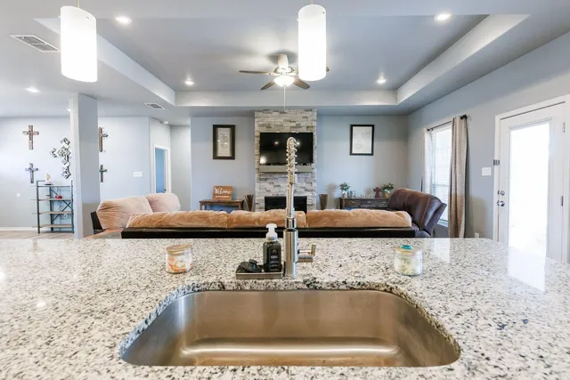 a kitchen with a faucet a sink and a granite counter top