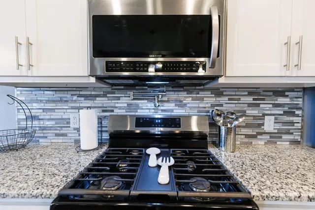 a kitchen with a stove and a microwave