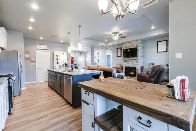 a view of kitchen with sink microwave and refrigerator