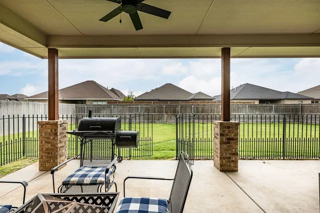 a view of a chairs and table in the balcony