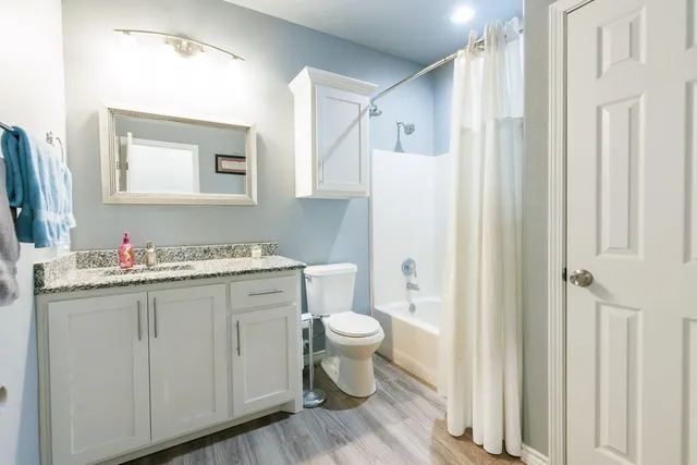 a bathroom with a sink toilet and shower