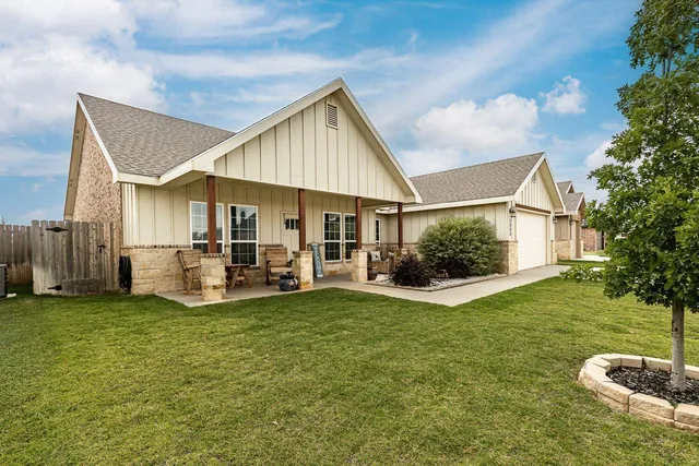a view of a house with a yard and sitting area