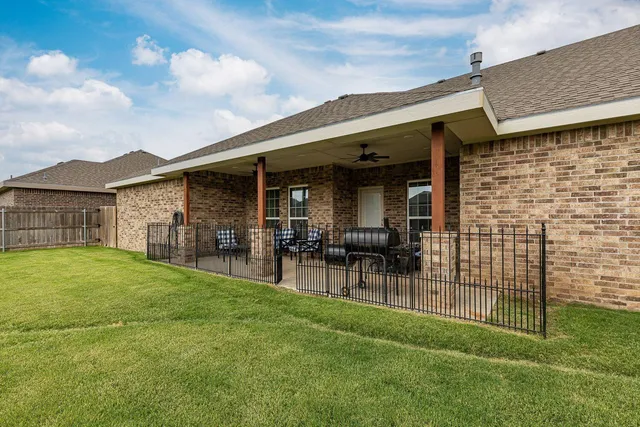 a view of a patio with a table and chairs