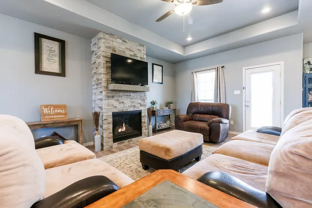 a living room with furniture fireplace and flat screen tv