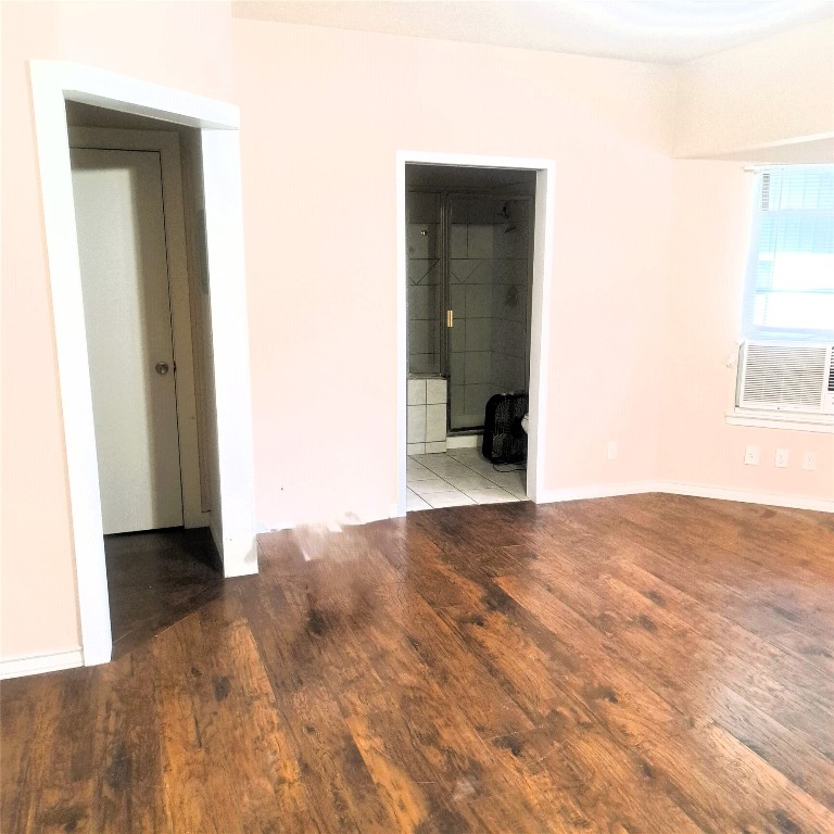 397 Lacy Drive, Unit B Elgin, TX 78621 - Photo 11 of 19 Spare room with wood-type flooring and cooling unit