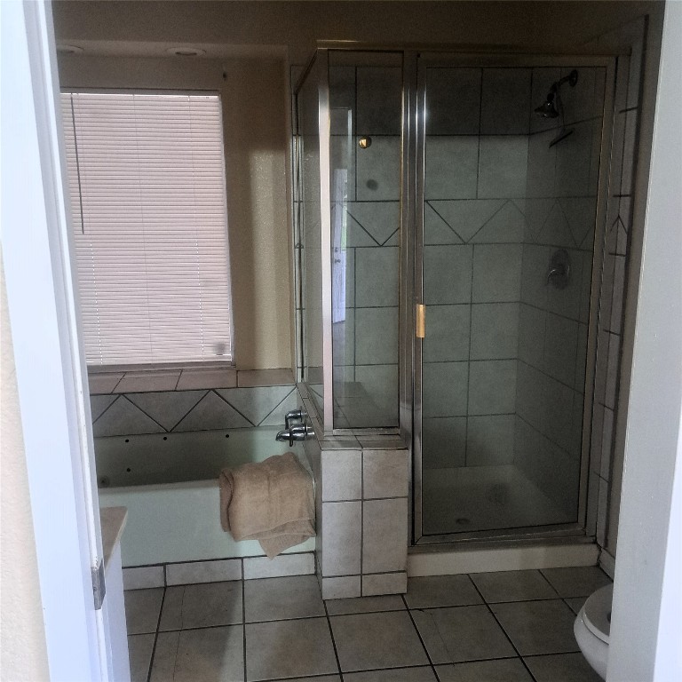 397 Lacy Drive, Unit B Elgin, TX 78621 - Photo 12 of 19 Bathroom with a shower stall, light tile patterned floors, and a bath