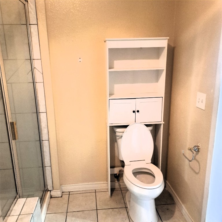 397 Lacy Drive, Unit B Elgin, TX 78621 - Photo 13 of 19 Bathroom with light tile patterned floors and a stall shower
