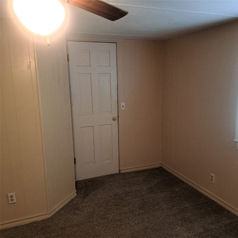 397 Lacy Drive, Unit B Elgin, TX 78621 - Photo 15 of 19 Spare room featuring dark carpet and a ceiling fan