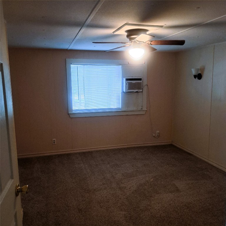 397 Lacy Drive, Unit B Elgin, TX 78621 - Photo 17 of 19 Spare room featuring dark colored carpet and a ceiling fan
