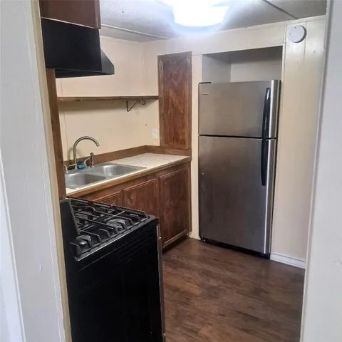 a kitchen with metallic refrigerator and a stove