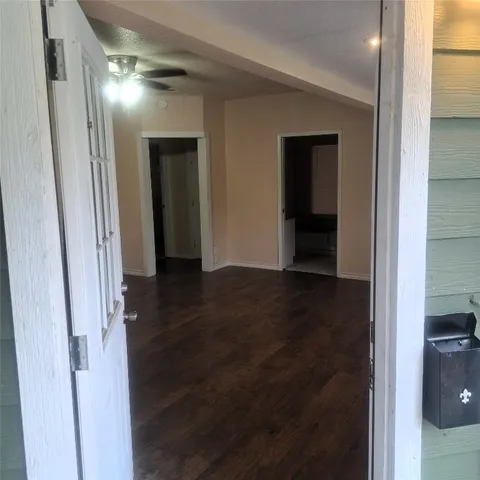 a view of hallway with wooden floor
