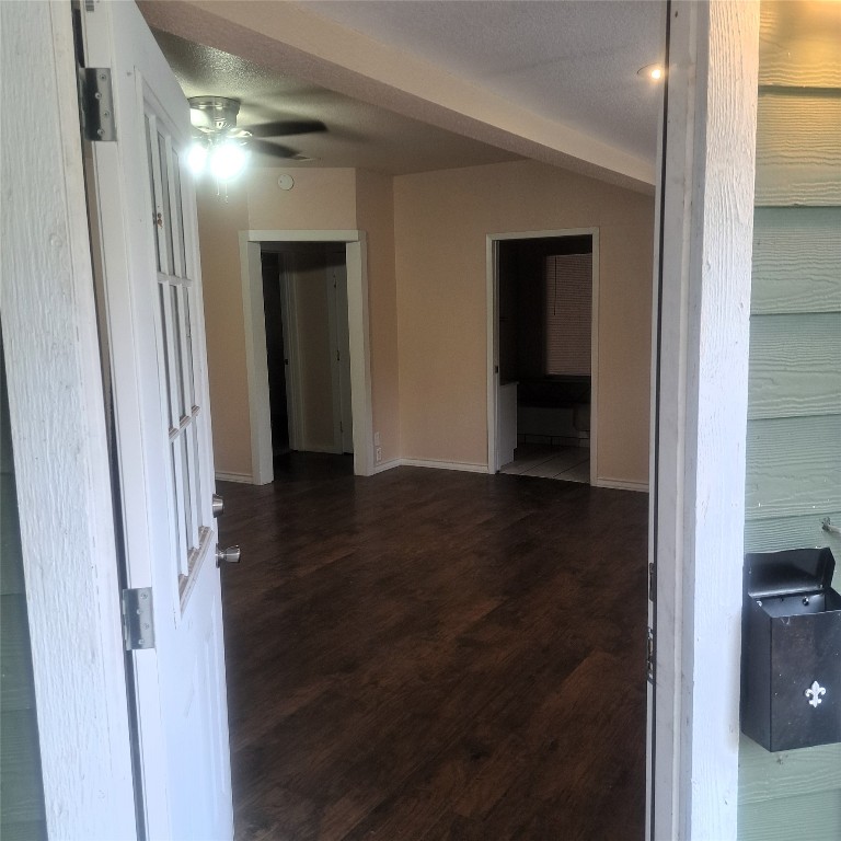 397 Lacy Drive, Unit B Elgin, TX 78621 - Photo 7 of 19 Hall featuring dark wood-style floors and baseboards