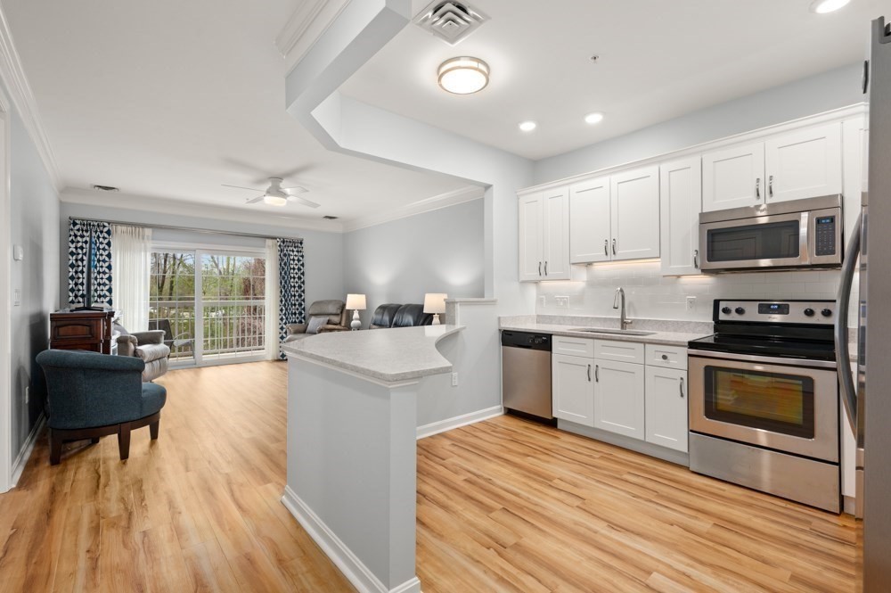 57 Augustus Court, Unit 1010 Reading, MA 01867 - Photo 11 of 32 a kitchen with a sink cabinets and stainless steel appliances