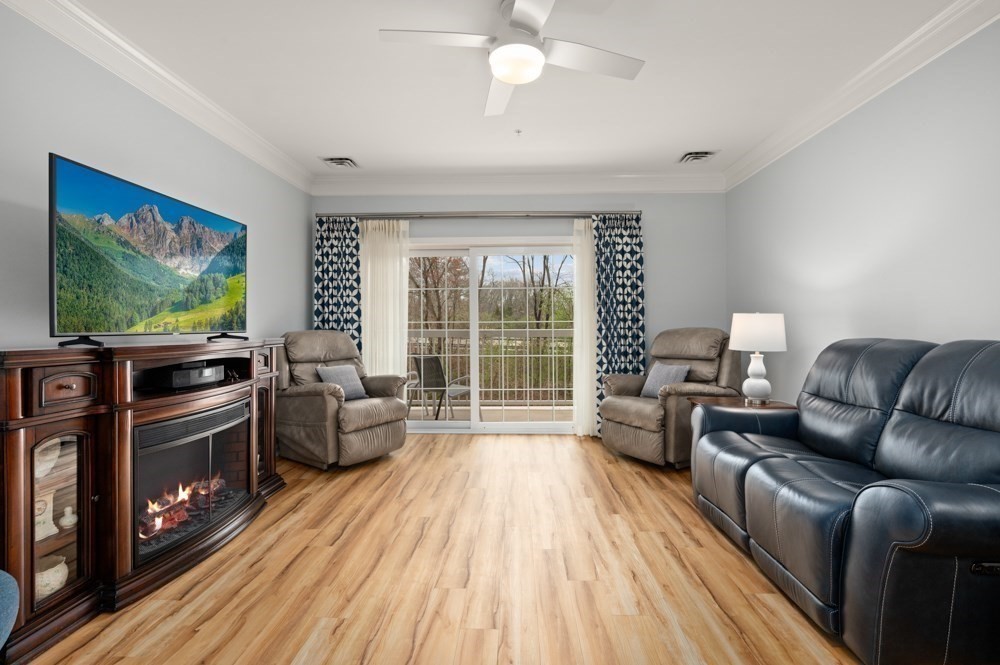 57 Augustus Court, Unit 1010 Reading, MA 01867 - Photo 14 of 32 a living room with furniture and a flat screen tv