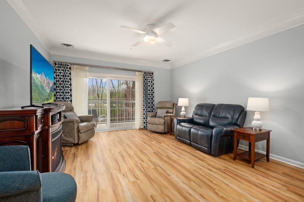 57 Augustus Court, Unit 1010 Reading, MA 01867 - Photo 15 of 32 a living room with furniture and a large window