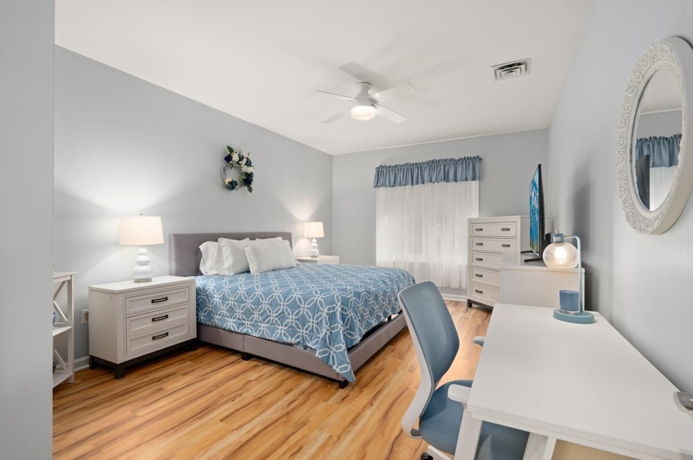 57 Augustus Court, Unit 1010 Reading, MA 01867 - Photo 19 of 32 a bedroom with a bed and a chandelier