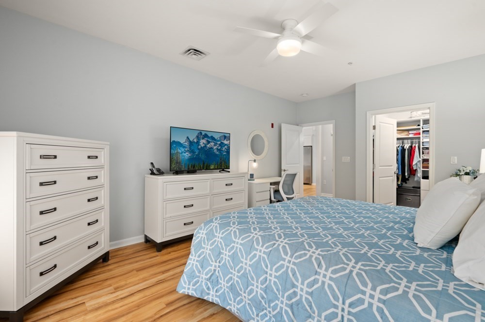 57 Augustus Court, Unit 1010 Reading, MA 01867 - Photo 20 of 32 a bedroom with a bed and a dresser