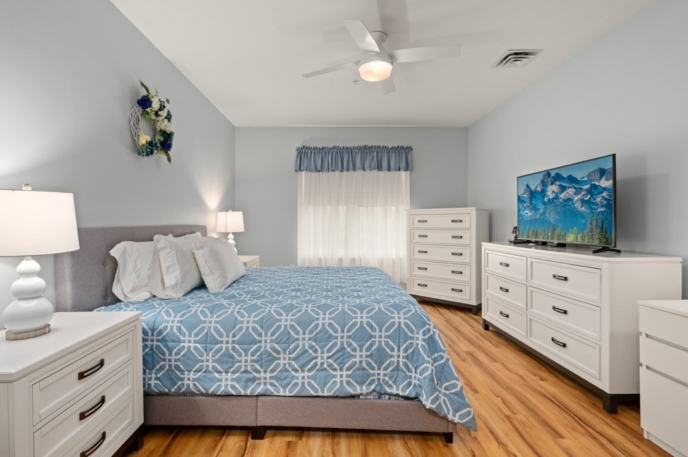 57 Augustus Court, Unit 1010 Reading, MA 01867 - Photo 21 of 32 a bedroom with a bed and a dresser in it